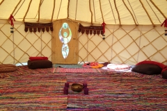 brown bean bags, red blankets on rag rugs with red banting